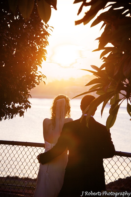 Bride and groom looking into the sunset - wedding photography sydney